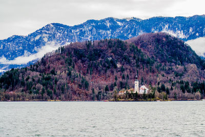 Scenic view of sea and mountains against sky