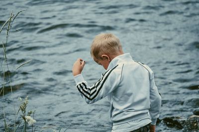 Rear view of boy in sea