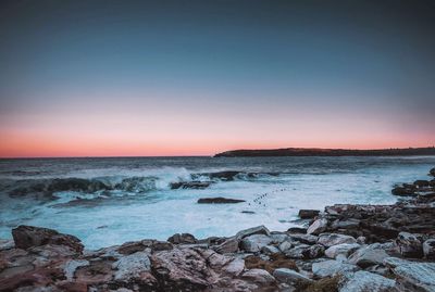 Scenic view of sea against clear sky during sunset