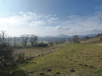 Scenic view of landscape against cloudy sky