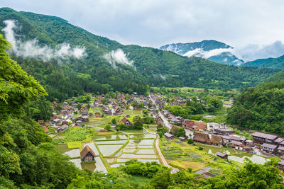 High angle view of houses and trees against sky