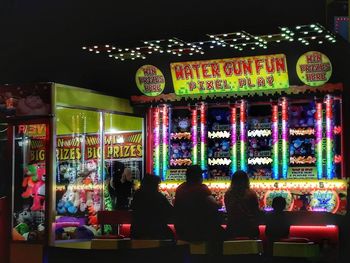 People in illuminated building at night