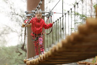 Low angle view of girl walking on footbridge