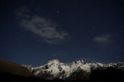 Scenic view of mountains against sky at night