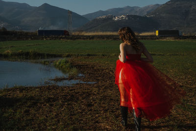 Rear view of woman standing on field