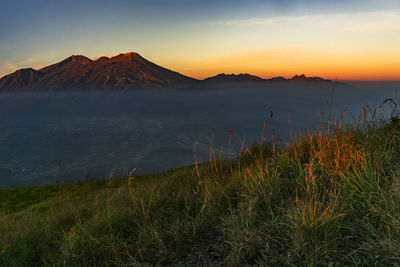 Scenic view of mountain against sky during sunset