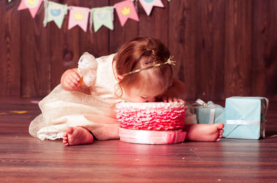 Cute baby girl eating cake