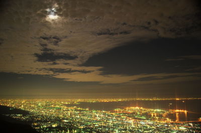 High angle view of illuminated buildings against sky at night