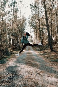 A person mid jumps a country road