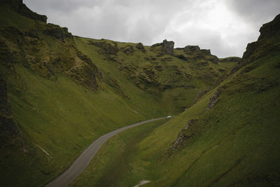 Scenic view of road amidst mountains against sky