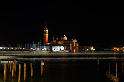 Light trails over grand canal by church of san giorgio maggiore against sky at night