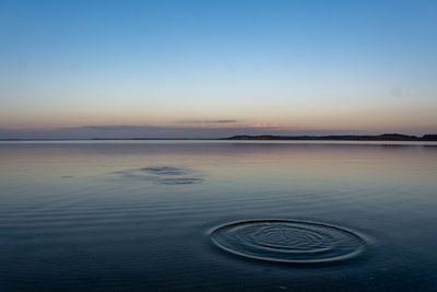 Scenic view of sea against clear sky during sunset