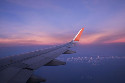 Airplane flying in taillight sky