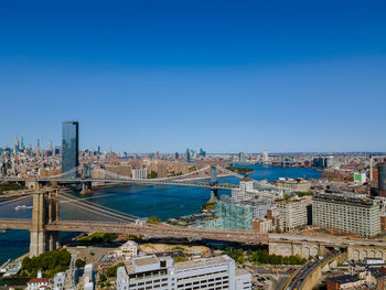 High angle view of buildings against clear blue sky