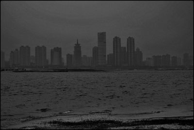 Scenic view of beach and buildings against sky