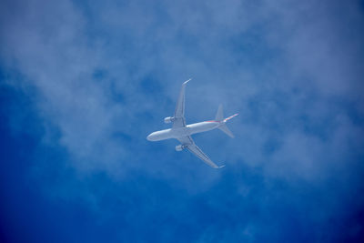 Low angle view of airplane flying in sky