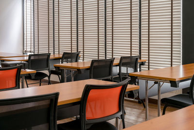 Empty chairs and tables in room