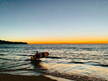 Scenic view of sea against clear sky during sunset