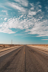 Empty road land against sky