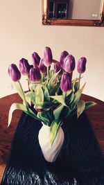 Close-up of tulips in vase on table at home