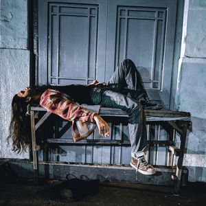 Full length of man lying down on table by door
