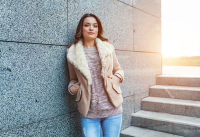 Portrait of woman standing in city during winter