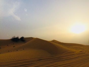 Scenic view of desert against sky during sunset