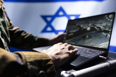 Midsection of man using laptop