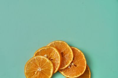 Close-up of orange fruit against white background