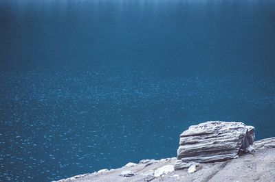 View of calm blue sea with rocky shore