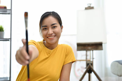 Portrait of young woman playing guitar