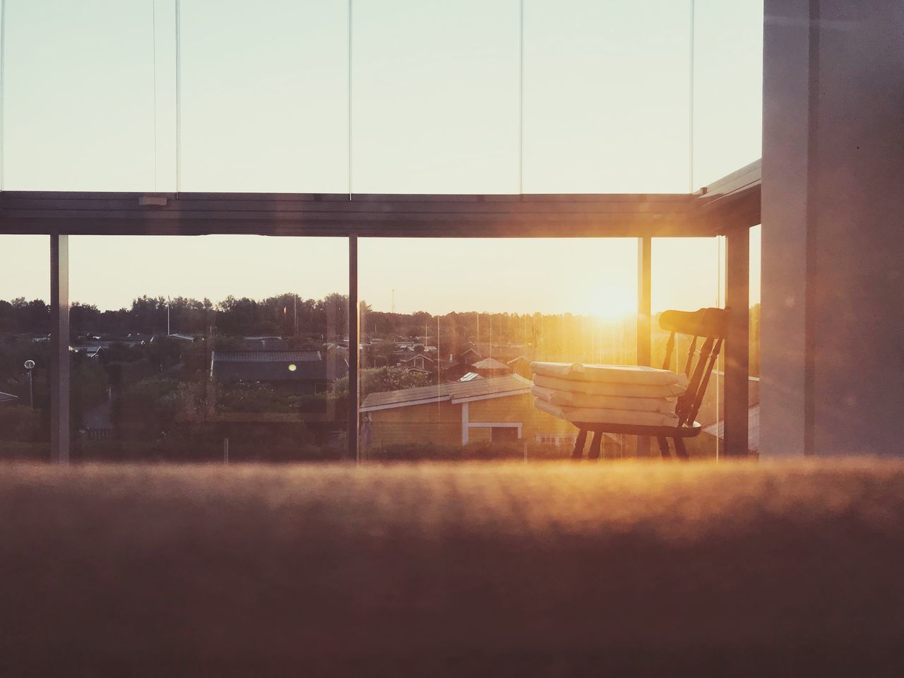 VIEW OF GLASS WINDOW AT SUNSET