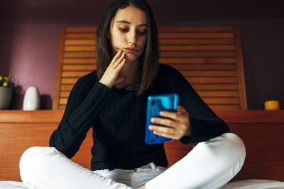 Woman watching the news sad and frustrated. bad news concept.