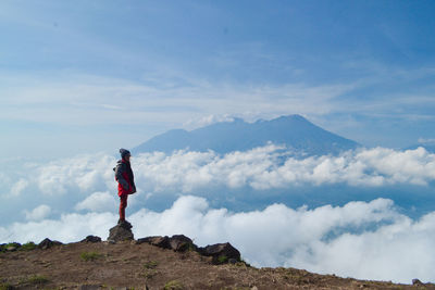 Man standing on mountain against sky