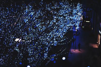 Low angle view of illuminated lights at night