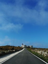Country road against sky