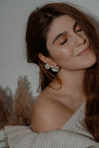 Close-up of beautiful smiling young woman at home