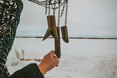 Cropped hand touching metal