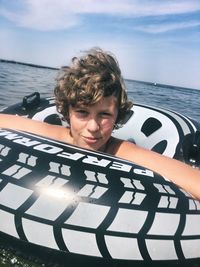 Portrait of boy against sea