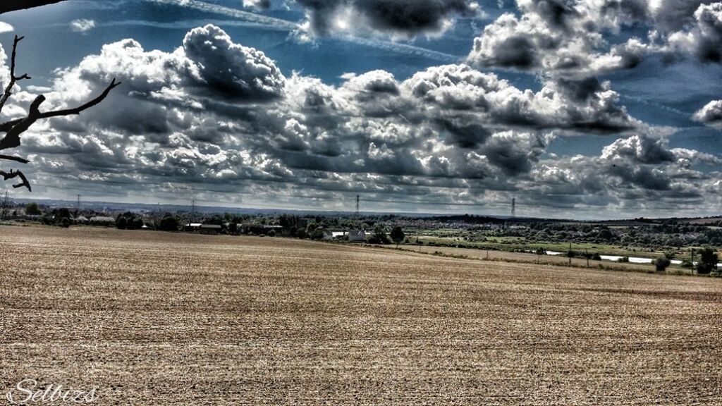 sky, cloud - sky, cloudy, tranquil scene, tranquility, landscape, scenics, cloud, beauty in nature, nature, field, road, sunlight, tree, weather, transportation, sunbeam, outdoors, day, water
