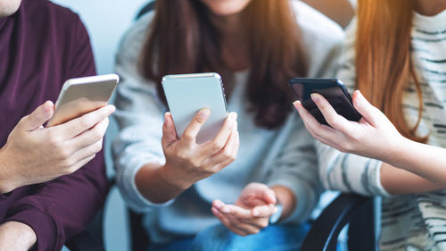 Midsection of woman using mobile phone
