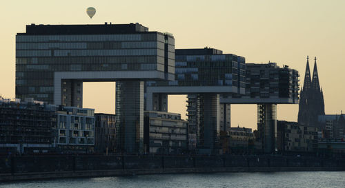 Modern buildings against sky during sunset in city