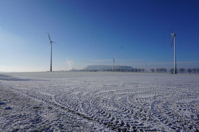 Scenic view of snowy field against sky