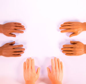 Close-up of hands over white background