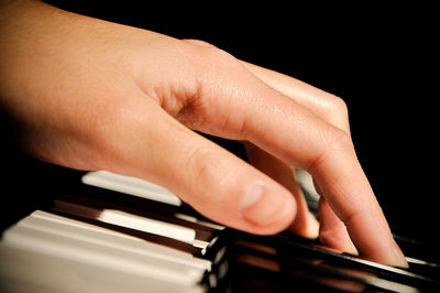 Close-up of hands playing piano