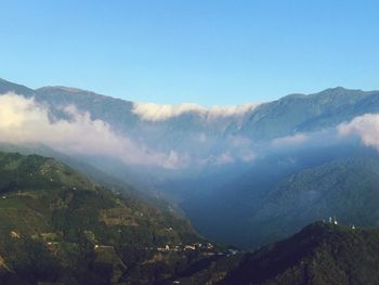 Scenic view of mountains against clear blue sky