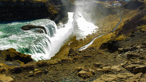 Scenic view of waterfall in sea