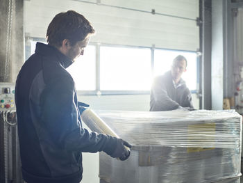 Workers closing freight with foil