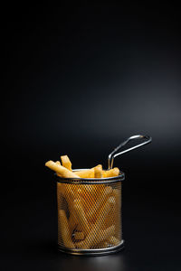 Close-up of drink in jar against black background