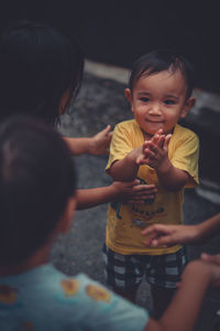 Cute boy playing with kids